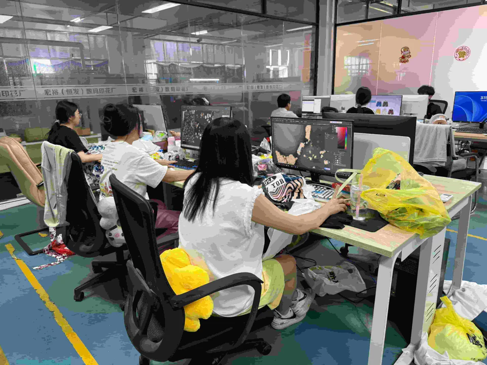Yumulin team working with garment graphics in the office